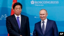  Russian President Vladimir Putin, right, and Chairman of National People's Congress Li Zhanshu prior to their talks on the sidelines of the Eastern Economic Forum in Vladivostok on September 7, 2022. (Associated Press)