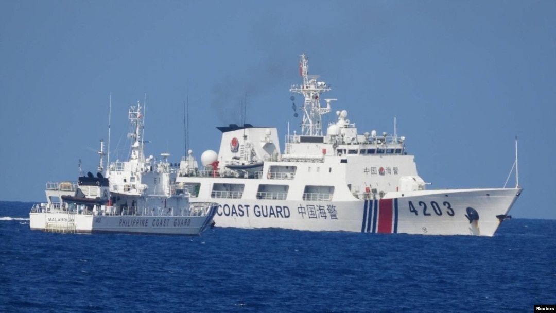 A Chinese Coast Guard ship allegedly obstructs a Philippine Coast Guard vessel as it provided support during a Philippine Navy operation in the disputed South China Sea, June 30, 2023 in this handout image released July 5, 2023.