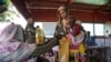 A handout photograph shot in January 2024 shows a woman and baby at the Zamzam displacement camp, close to El Fasher in North Darfur, Sudan. (MSF/Mohamed Zakaria/Handout)