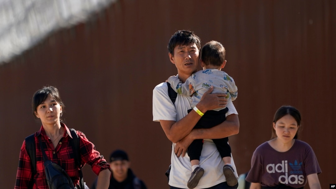 FILE - Migrants walk after crossing the U.S.-Mexico border near Jacumba, California, Oct. 24, 2023. China has resumed cooperating with the U.S. to repatriate Chinese migrants illegally stranded in the U.S., The Associated Press reported Thursday.   