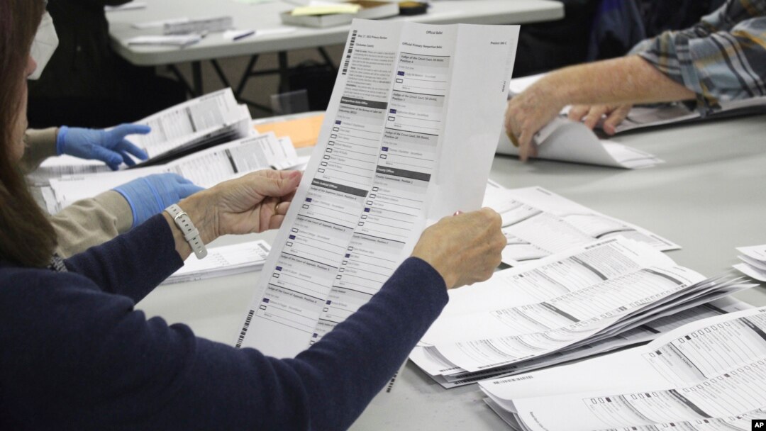 FILE - An election worker examines a ballot on May 19, 2022, in Oregon City, Oregon. No Labels, a group that could shake up the 2024 U.S. presidential race with a bipartisan "unity ticket," secured access to the ballot in Oregon on March 10, 2023.