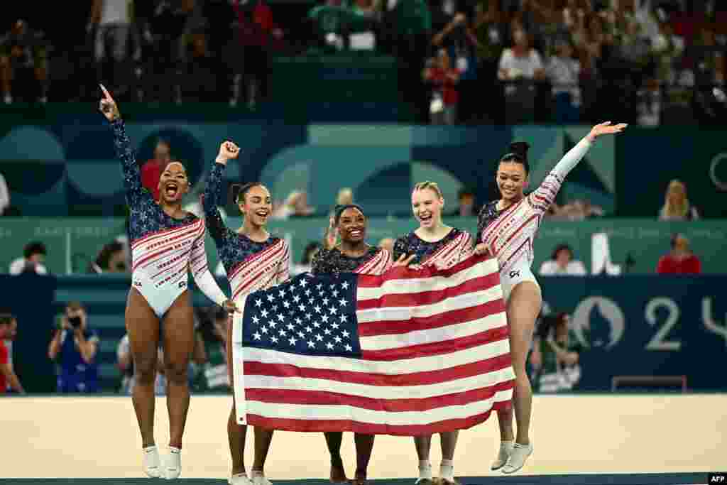 Simone Biles, center, and her teammates celebrate after Team USA won the artistic gymnastics women's team final during the Paris 2024 Olympic Games at the Bercy Arena in Paris, July 30, 2024.