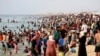 Palestinian family members displaced by the ongoing war with Israel seek relief from heat along the Mediterranean Sea at Khan Younis beach, Gaza Strip, May 20, 2024.
