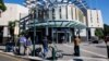 Members of the media stand outside the Brisbane Watch House in Brisbane on July 12, 2024, where a 40-year-old woman and her 62-year-old husband appeared before a magistrate after being charged with "preparing for an espionage offense".