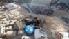 Palestinians inspect the site of an Israeli strike on a house, amid the conflict between Israel and the Palestinian Islamist group Hamas, in Rafah, in the southern Gaza Strip, May 8, 2024.