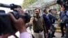 Police officers stand outside a building housing BBC offices as tax officials conduct a search of the premises, in New Delhi, India, Feb. 14, 2023. 