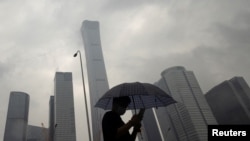 2023年7月12日，中国北京雨天，一名男子行走在中央商务区。（路透社照片）