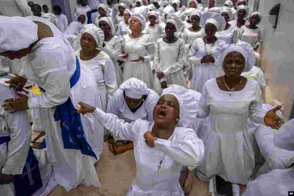 Members of the congregation sing and chant during a church service in which they prayed for the country ahead of elections, at the Celestial Church of Christ Olowu Cathedral on Lagos Island in Nigeria.
