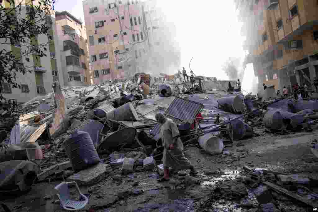 Palestinians inspect the rubble of a building after it was struck by an Israeli airstrike in Gaza City, Oct. 7, 2023. 