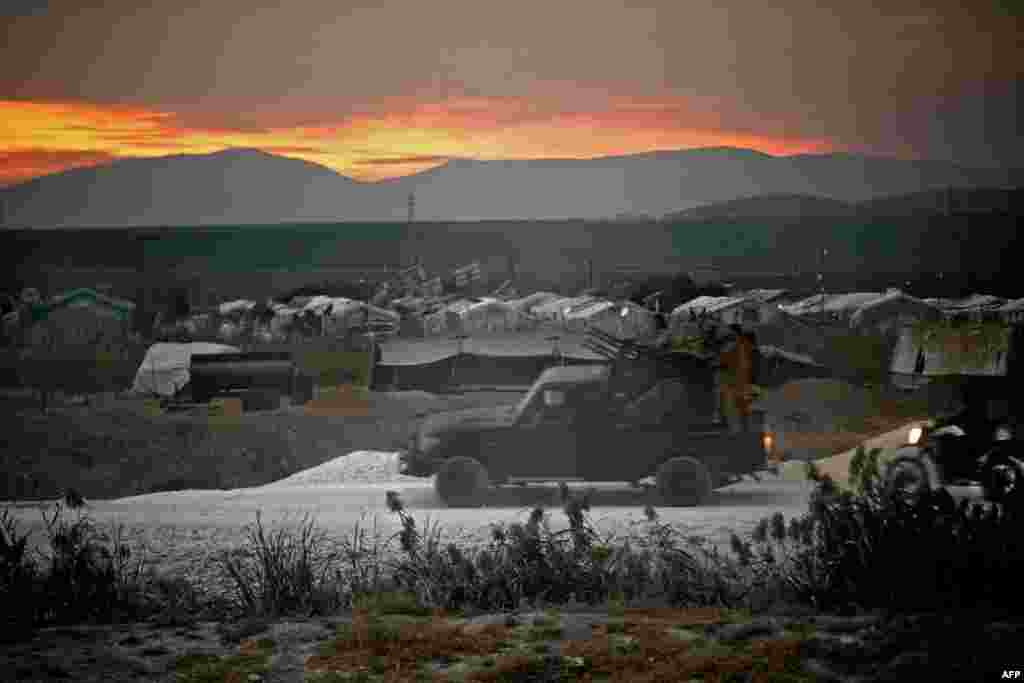 Members of the Hayat Tahrir al-Sham (HTS) jihadist group advance towards the village of Jindayris in the Afrin region of Syria's rebel-held northern Aleppo province, Oct. 12, 2022, amid ongoing reported clashes between rival factions competing for power.