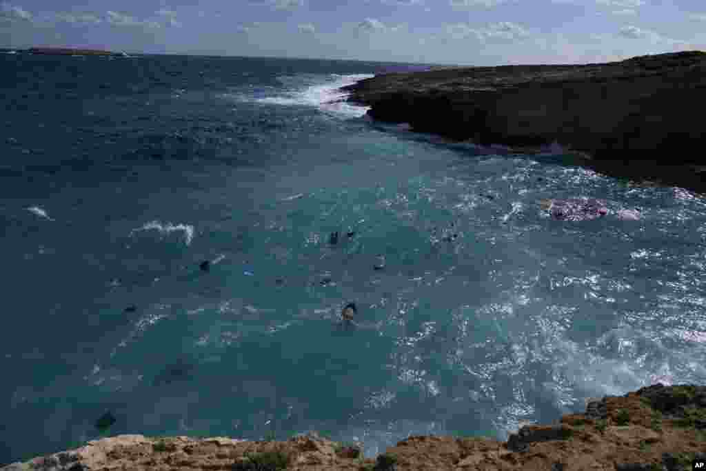 Bodies of migrants are seen floating after a sailboat carrying migrants smashed into rocks and sank off the island of Kythira, southern Greece.