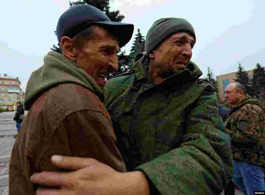A serviceman hugs his brother after being released along with other military personnel from Russian-controlled parts of Donetsk and Luhansk regions in recent prisoner exchange in the town of Amvrosiivka (Amvrosievka), Donetsk region, Russian-controlled Ukraine.