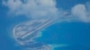 An airstrip made by China is seen beside structures and buildings at the man-made island on Mischief Reef in the South China Sea on March 20, 2022. (Aaron Favila/AP)
