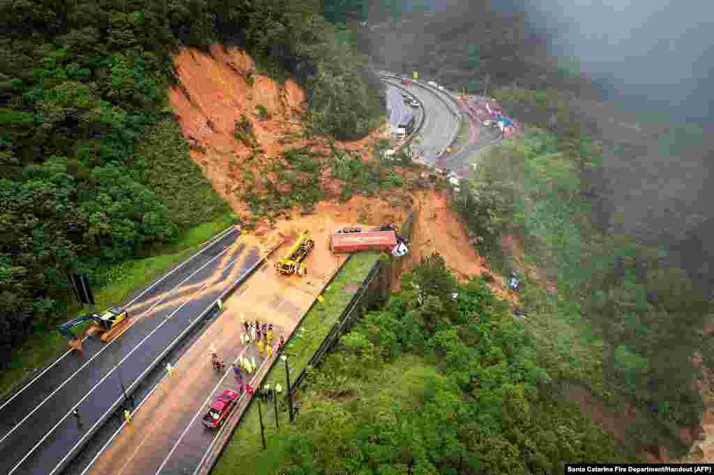 The BR-367 highway is seen blocked after a landslide in Guaratuba, Parana state, Brazil. Two people were found dead and at least 30 were missing in a landslide that swept away about 20 vehicles on a road in southern Brazil, firefighters estimated.