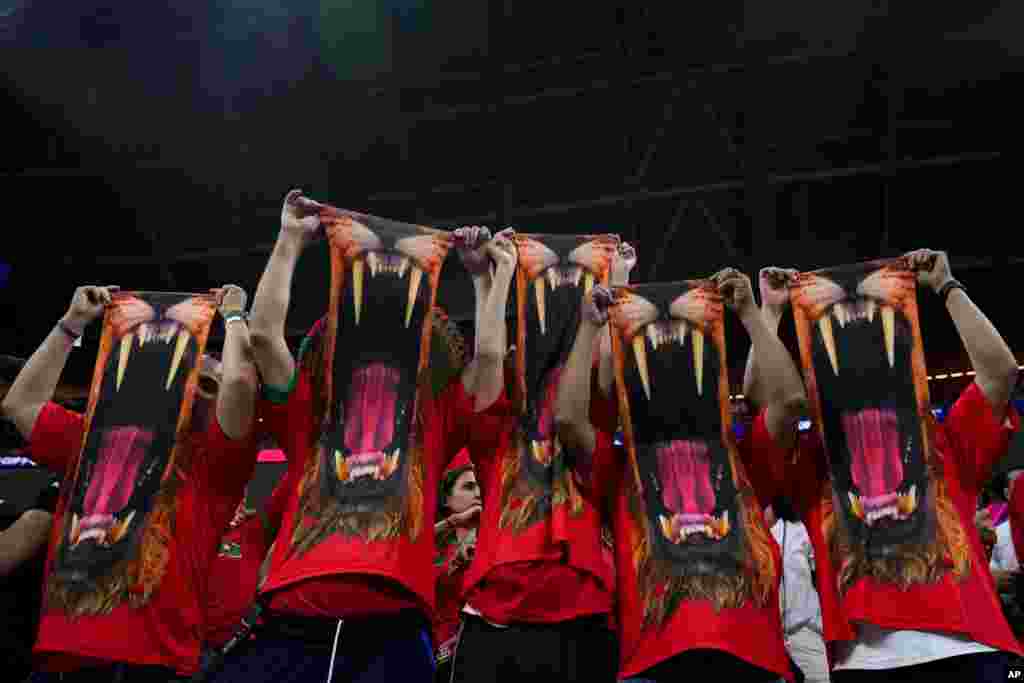 Fans of Morococo display masks prior to the World Cup semifinal soccer match between France and Morocco at the Al Bayt Stadium in Al Khor, Qatar.
