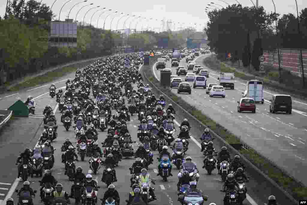 Several hundred motor-bikers block the ring road in Toulouse, south-western France, Nov. 26, 2022, to contest the decision of the Council of State to impose technical control on motorized two-wheelers. 