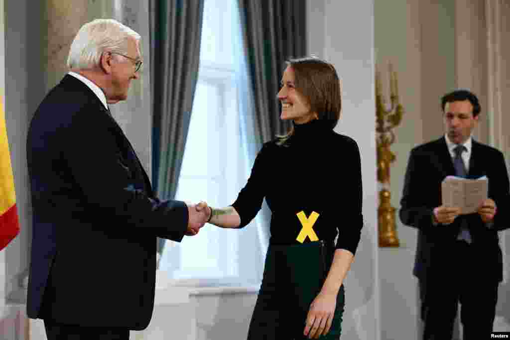 German President Frank-Walter Steinmeier shakes hands with Hannah Fischer, a packaging-free store owner from Dortmund, at the annual New Year reception at Bellevue palace in Berlin.