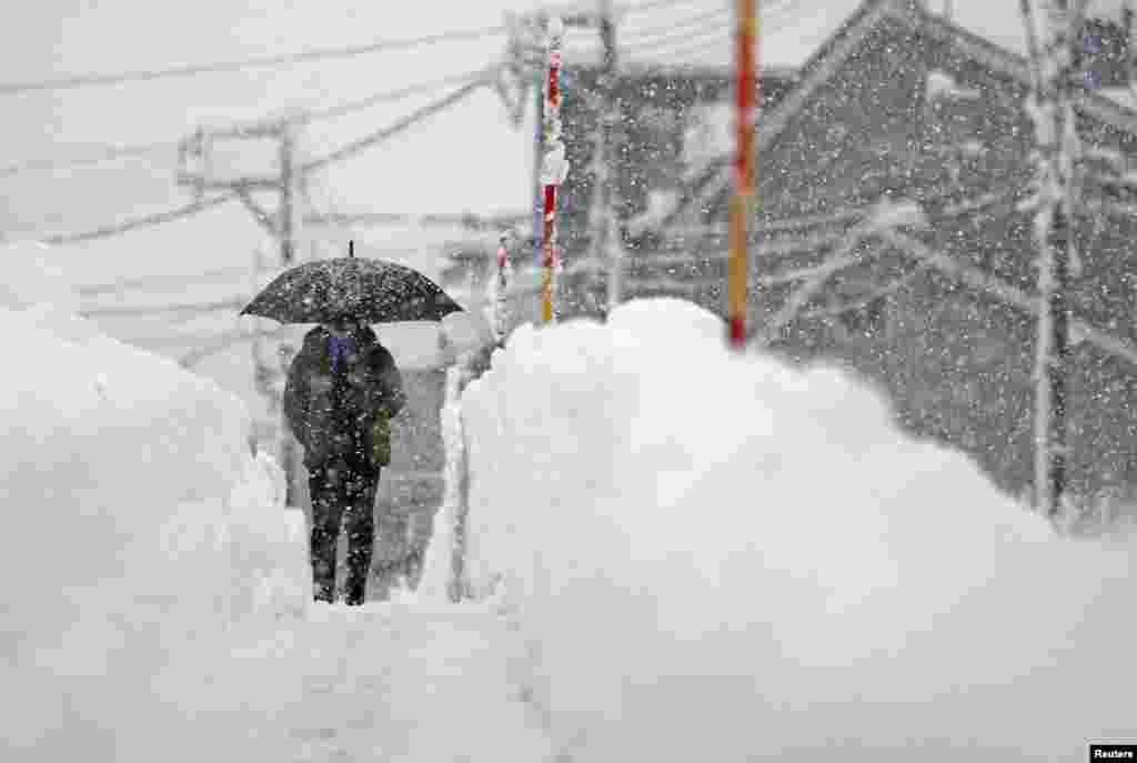 A man makes his way in the heavy snow in Uonuma, Niigata Prefecture, Japan, in this photo taken by Kyodo.