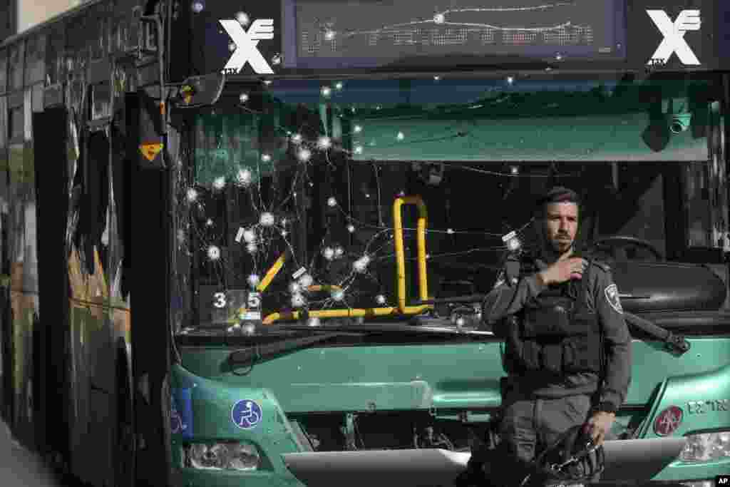 Israeli police inspect the scene of an explosion at a bus stop in Jerusalem. Two blasts have gone off near bus stops in Jerusalem, killing one person and injuring a dozen of people, in what Israeli police said were suspected attacks by Palestinians. 