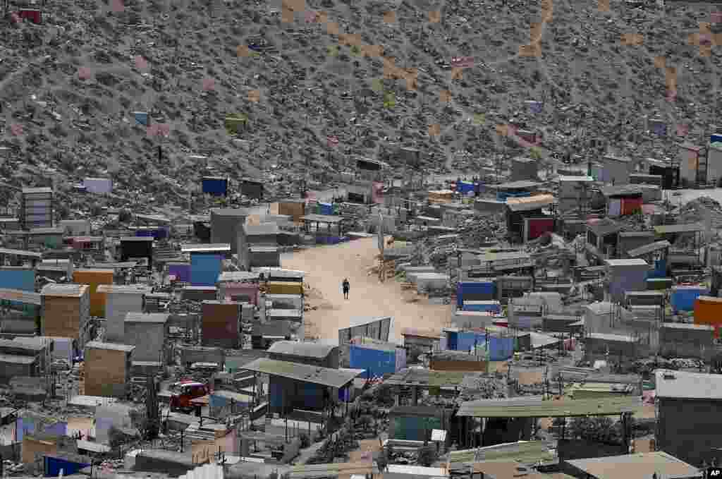A person walks through the Virgin of Lourdes Cemetery in Lima, Peru.