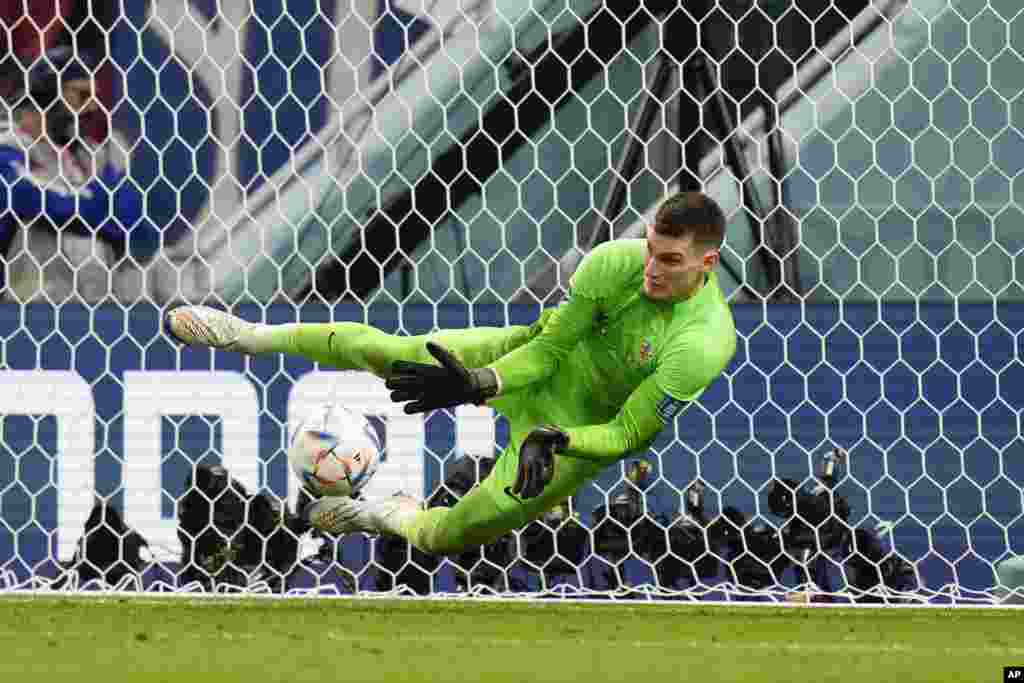 Croatia's goalkeeper Dominik Livakovic makes a save during the penalties shootout during the World Cup round of 16 soccer match between Japan and Croatia at the Al Janoub Stadium in Al Wakrah, Qatar. Croatia won a penalty shootout 3-1 to qualify for the next round.