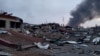 Smoke rises amid damaged buildings following an attack on the Yavoriv military base, as Russia's invasion of Ukraine continues, in Yavoriv, Lviv Oblast, Ukraine, March 13, 2022 in this picture obtained from social media. (@BackAndAlive/via Reuters) 