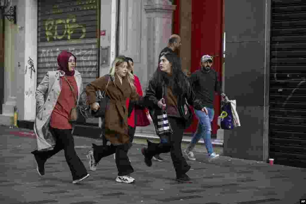 People run from the area after an explosion on Istanbul's popular pedestrian Istiklal Avenue Istanbul, Turkey.