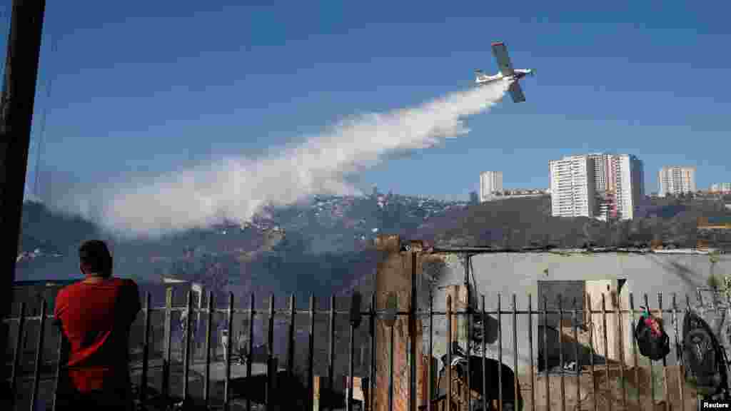 An aircraft makes a water drop after a wildfire in Vina del Mar, Chile.