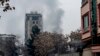 FILE - Smoke rises from a site of an attack at Shahr-e-naw which is city's one of main commercial areas in Kabul, Dec. 12, 2022. The Islamic State Khorasan Province group has released a video of two men it claims conducted Monday’s attack.