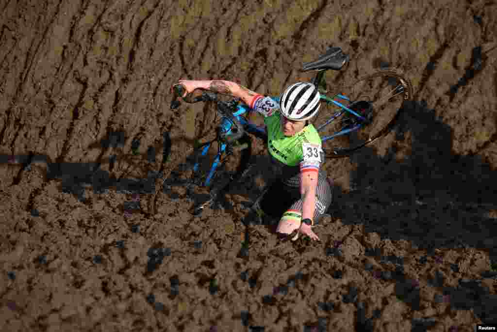 A competitor stumbles during the Junior women's race at the British Cyclocross championships near Milnthorpe, Britain.