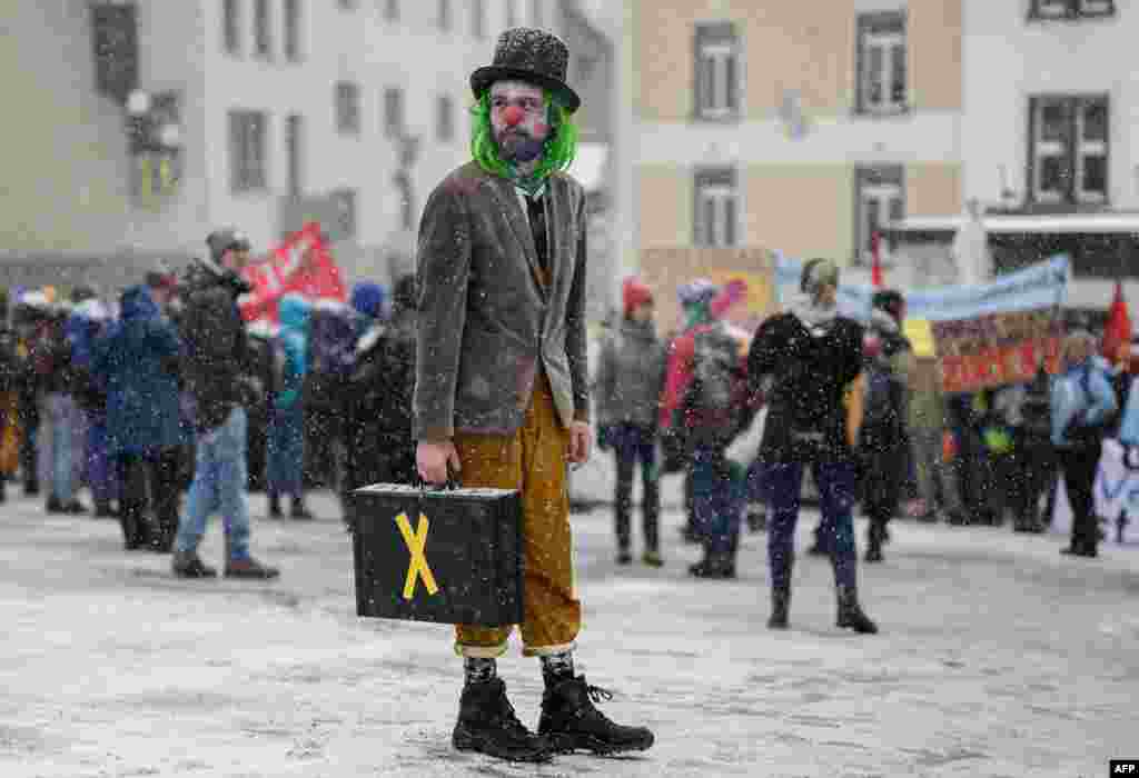 Young Socialists Switzerland (JUSO) activists take part in a protest against the World Economic Forum (WEF), calling for a climate tax on the rich, on the eve of the WEF annual meeting in Davos.