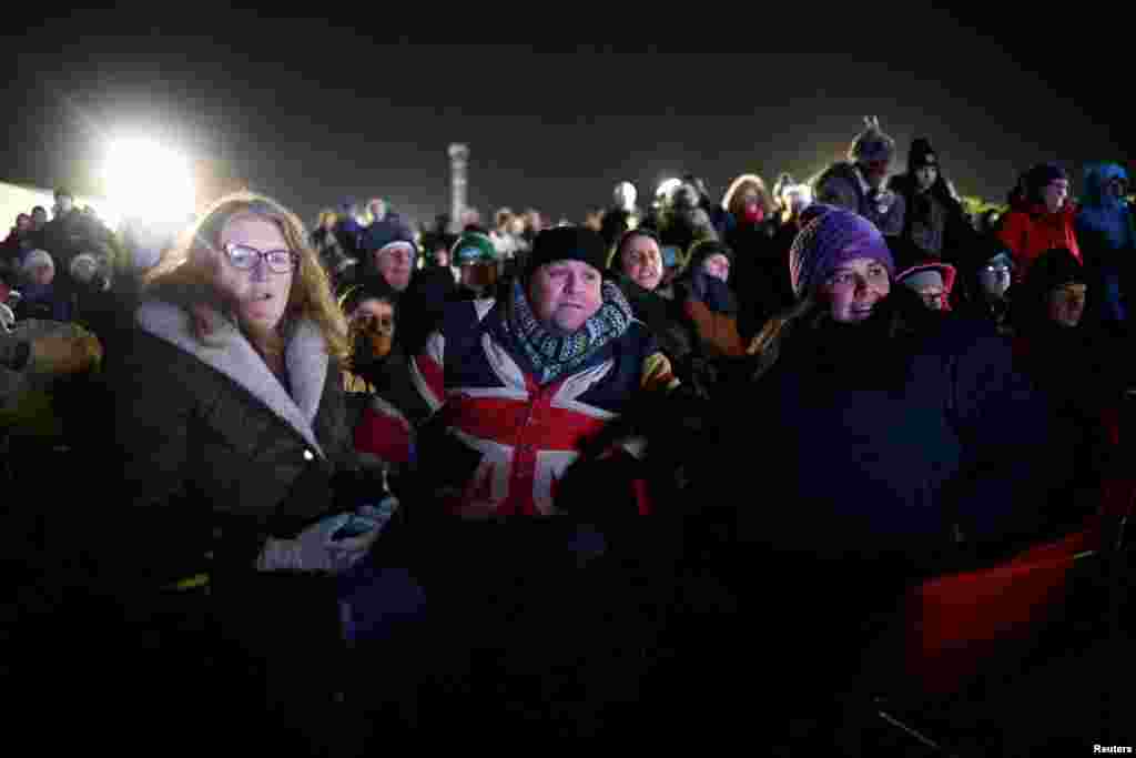 People watch Britain's first satellite launch, on a TV screen at Cornwall Airport Newquay, in Cornwall, Britain, Jan. 9, 2023.