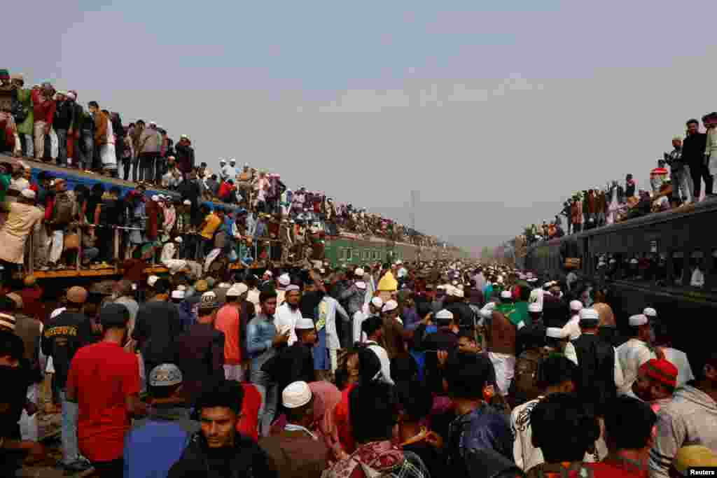 Devotees climb on the rooftop of an overcrowded train to return home, after attending the final prayer of Bishwa Ijtema, which is considered the world’s second-largest Muslim gathering after Haj, in Tongi, outskirts of Dhaka, Bangladesh. 