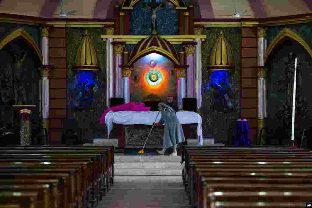 A nun mops the floor of a church ahead of Christmas in Guwahati, India.