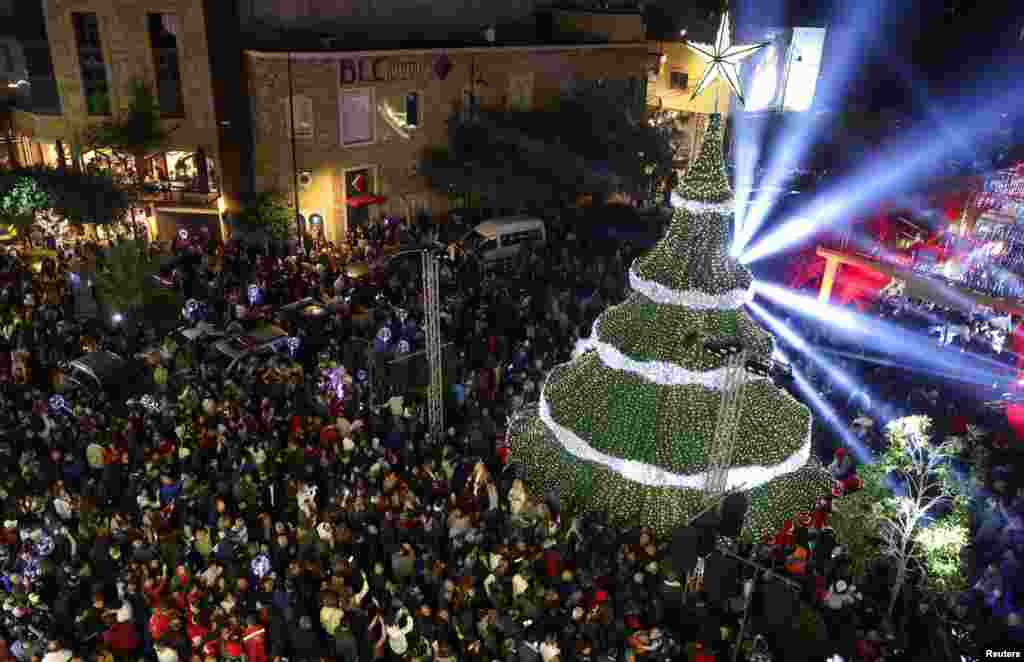 People gather during a Christmas tree lighting ceremony in Byblos, Lebanon.