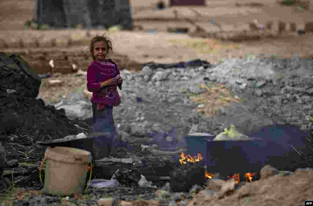 A Syrian girl stands is seen at the Sahlah al-Banat camp for displaced people in the countryside of Raqa in northern Syria, Nov. 7, 2022.