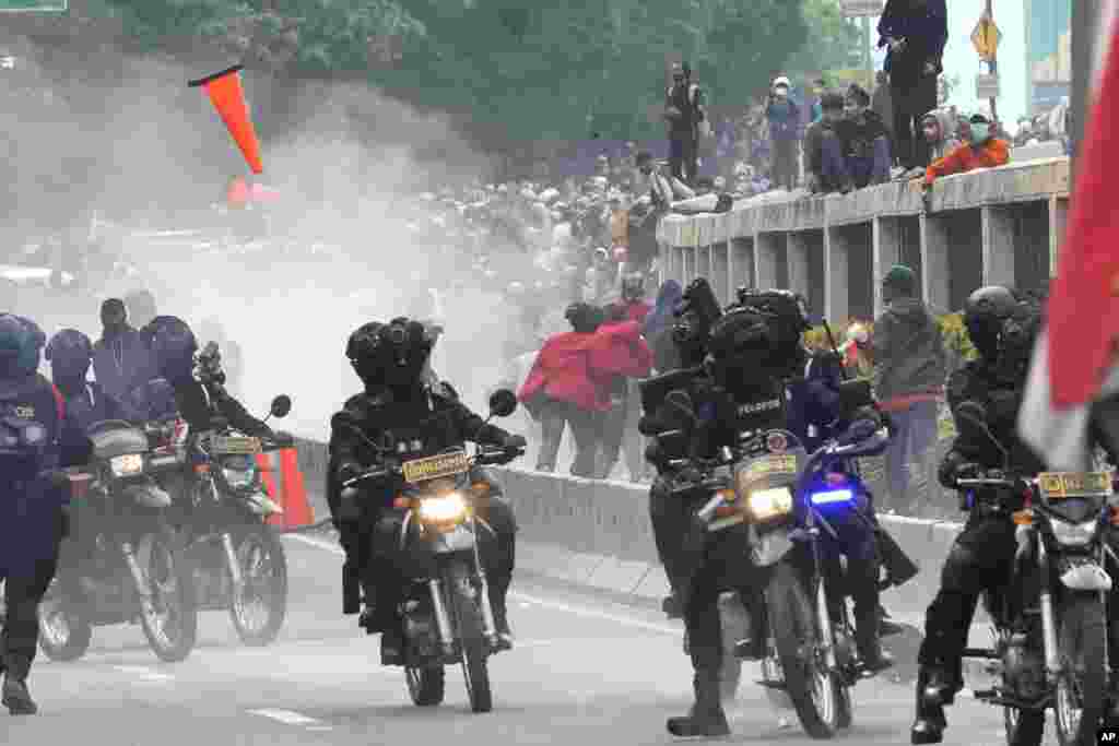 Police disperse protesters during a rally in Jakarta, Indonesia, April 11, 2022. Thousands of students marched in cities across the country to protest against rumors that the government is considering postponing the 2024 presidential election to allow President Joko Widodo to remain in office beyond the two-term legal limit, calling it a threat to the country's democracy. 