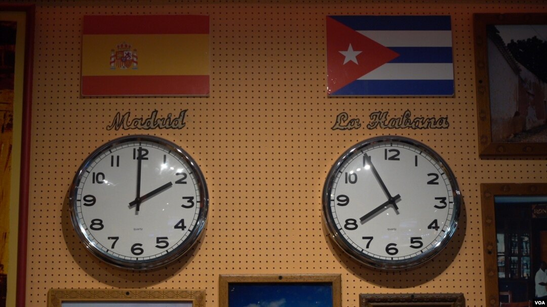 Representations of journalist Abraham Jimenez Enoa's new home in Spain and previous home in Cuba hang on a wall. (Alfonso Beato/VOA)
