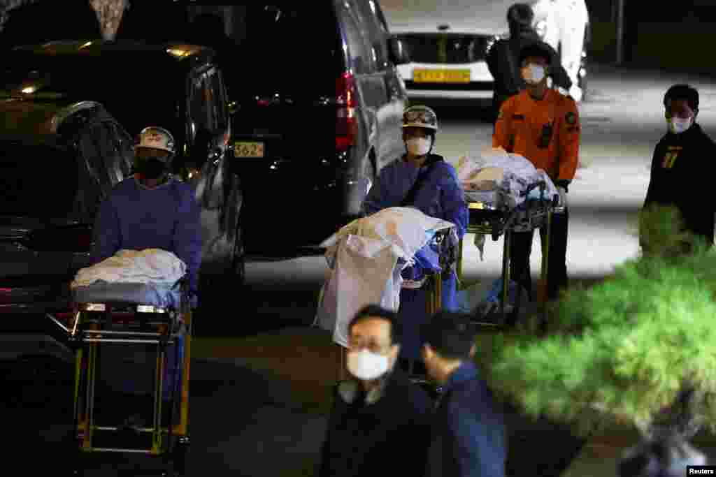 People move bodies to be transported from hospital, after a stampede during a Halloween festival in Seoul, South Korea. At least 151 people were killed and 82 people were injured in the incident in Seoul's Itaewon area, which had been packed with crowds ahead of the Monday holiday, officials said.
