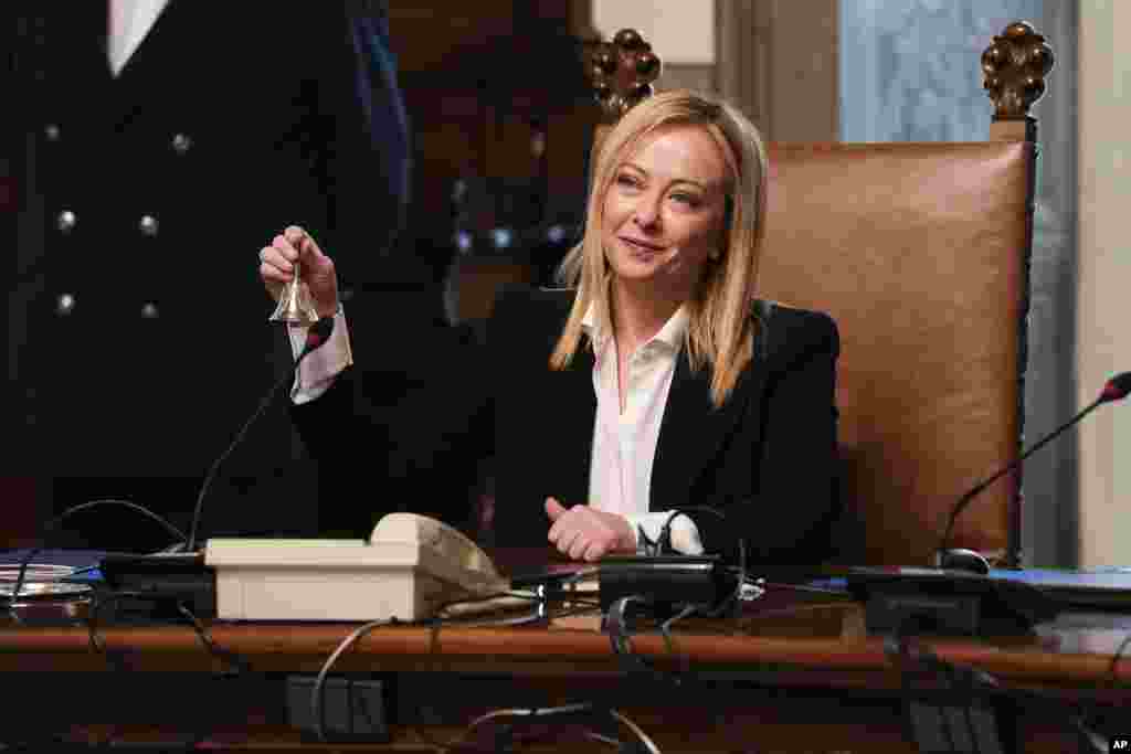 New Italian Premier Giorgia Meloni rings the cabinet minister bell during her first cabinet meeting at Chigi Palace Premier's office, in Rome. Giorgia Meloni, 45, whose political party with neo-fascist roots secured the most votes in Italy's national election last month, took office as the country's first far-right premier since the end of World War II. She is also the first woman to serve as premier.
