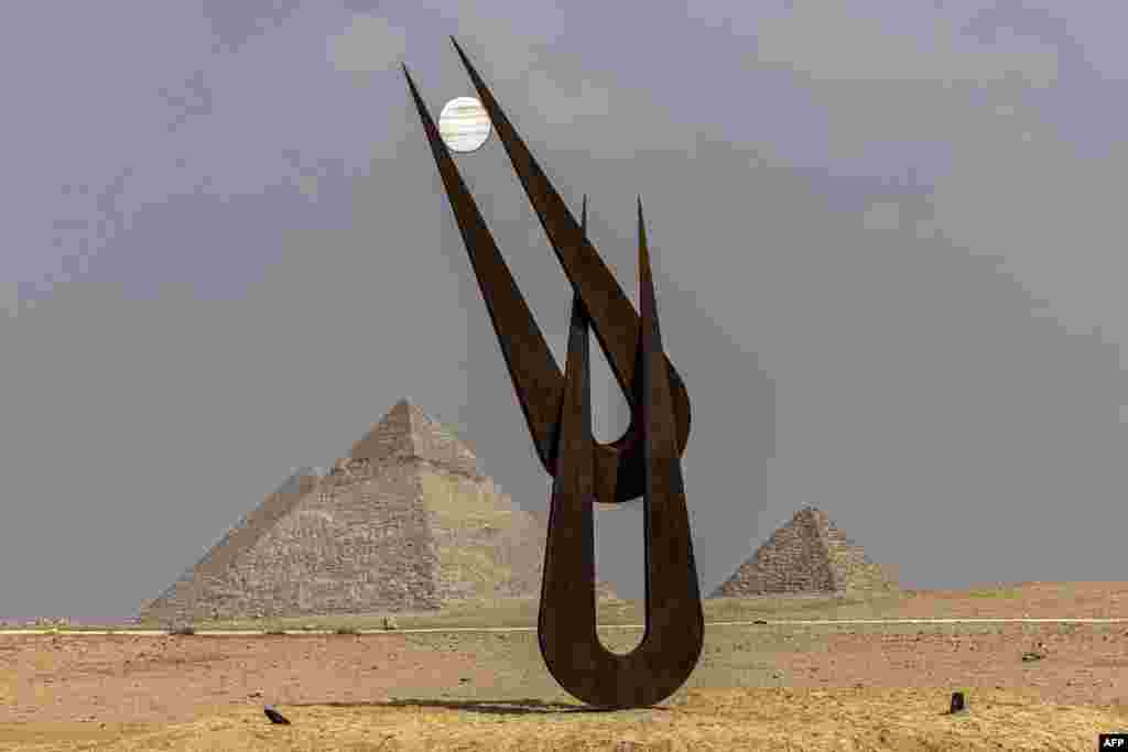 A view of the sculpture "Spirit of Hathor" by British-American sculptor, collector, art advisor, educator, and author Natalie Clark at the Giza pyramids necropolis during the second edition of the Art DÉgypte exhibition "Forever is Now".