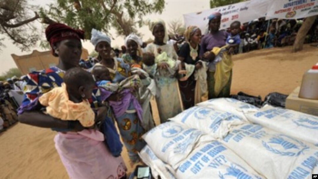 Women wait to receive baby food in Koleram, southern Niger, during the launch of a UN-backed feeding operation aimed at fighting malnutrition among young children.