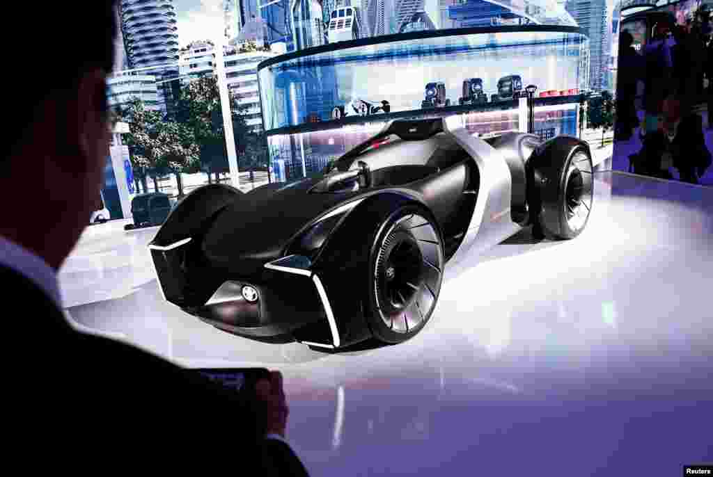 People take photos of Toyota's e-Racer concept car at the Tokyo Motor Show, in Tokyo, Japan, Oct. 23, 2019.
