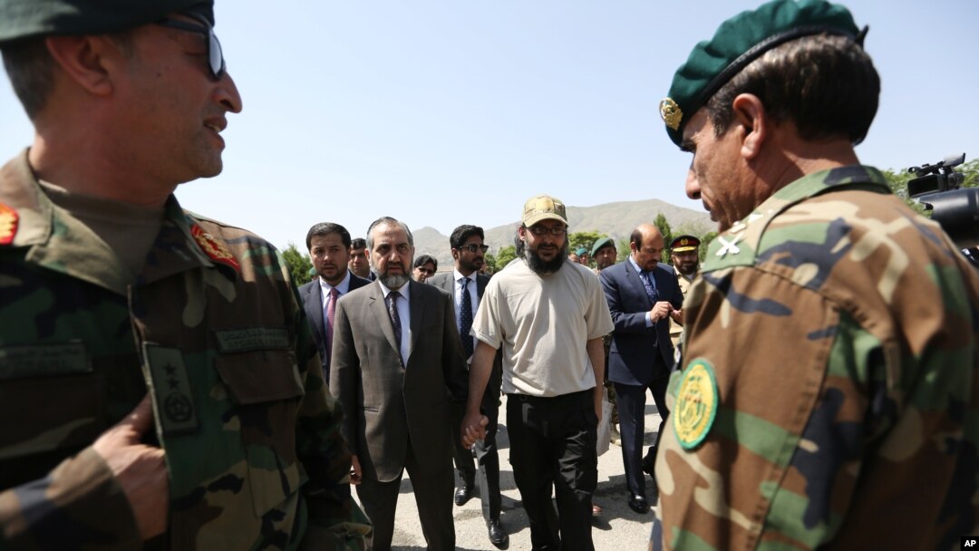 Ali Haidar Gilani son of a former Pakistani prime minister, right, walk with Pakistan Ambassador Abrar Hussain, left, as he arrives at the Ministry of Defense in Kabul, Afghanistan, Wednesday, May, 11, 2016.