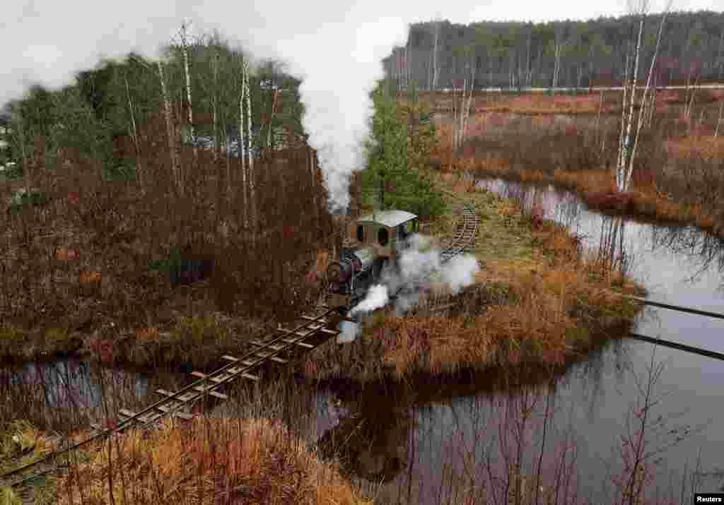 A home-made steam train, designed by Pavel Chilin, rides on a make-shift railway across country house neighborhood in the settlement of Ulyanovka in Leningrad region, Russia, Nov. 4, 2019.