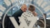 Men speak inside PMC Wagner Center, a project implemented by the businessman and founder of the Wagner private military group Yevgeny Prigozhin, during the official opening of the office block in Saint Petersburg on November 4, 2022. (Igor Russak/Reuters)