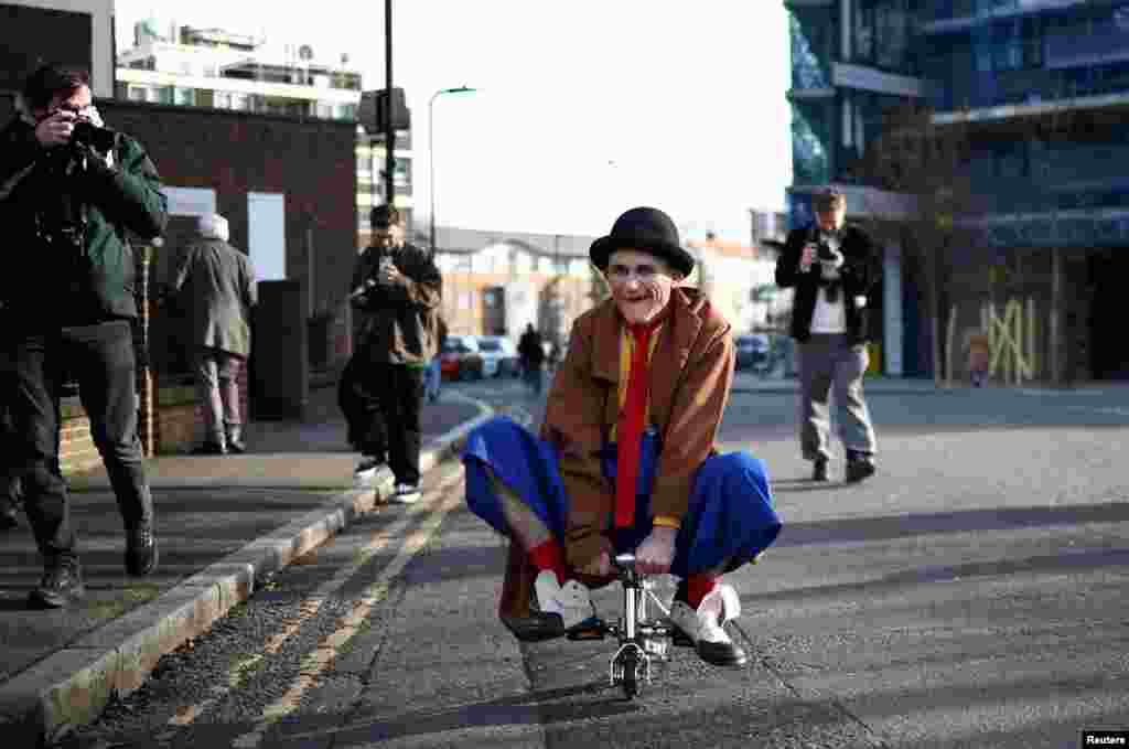 A clown poses for photographers ahead of the annual service of remembrance in honor of British clown Joseph Grimaldi, at the All Saints Church in Haggerston, London.