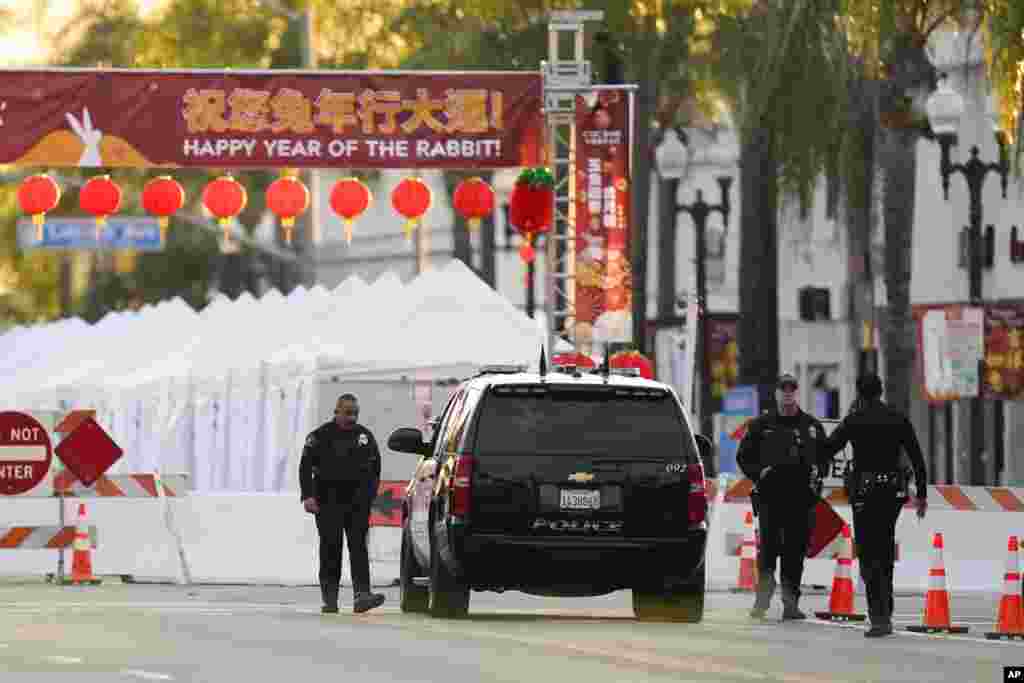 Police officers stand outside a ballroom dance club in Monterey Park, California. A gunman killed 10 people at a ballroom dance studio amid Lunar New Year celebrations and then may have tried — but failed — to target a second dance hall, authorities said. 