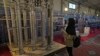 A student looks at Iran's domestically built centrifuges in an exhibition of the country's nuclear achievements, in Tehran, Iran on February 8, 2023. (Vahid Salemi/AP)