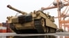 FILE - An M1A2 Abrams battle tank of the US army that will be used for military exercises by the 2nd Armored Brigade Combat Team, is unloaded at the Baltic Container Terminal in Gdynia, Poland, Dec. 3, 2022.
